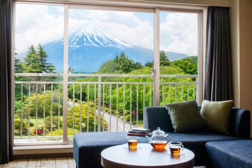 a living room filled with furniture and a window at Fuji View Hotel in Fujikawaguchiko