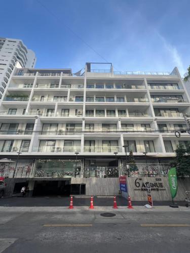 a large white building with orange cones in front of it at 6th Avenue Sukhumvit BKK 407 BTS Asoke Nana in Bangkok