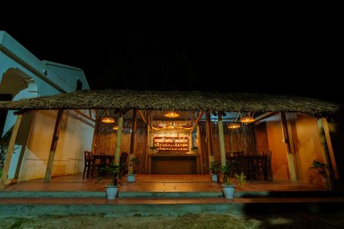 a restaurant with a bar with chairs and a table at Charm Vân Long in Ninh Binh