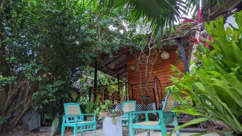 a group of blue chairs in front of a cabin at Soul Villas & Cabana Near Beach with Pool in Tangalle