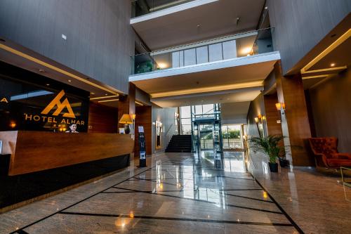 a hotel lobby with a hotel album sign on the wall at Hotel Alhar in Lubliniec