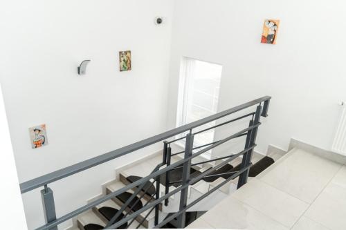a staircase in a house with white walls at Sky Rooms in Sub Coastă