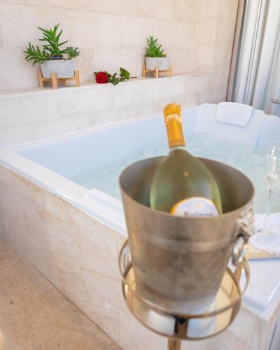 a bottle of wine in a bucket in a bath tub at Hôtel Le Roquebrune in Roquebrune-Cap-Martin