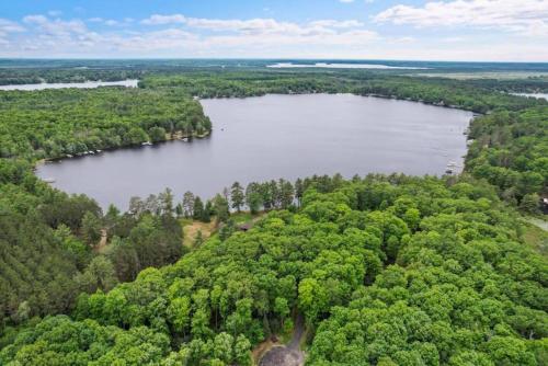 an aerial view of a lake in the middle of a forest at Lake Breeze Luxury Executive Retreat in Three Lakes