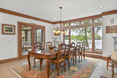 a dining room with a wooden table and chairs at Lake Breeze Luxury Executive Retreat in Three Lakes