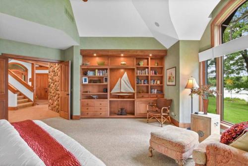 a bedroom with a bed and a large window at Lake Breeze Luxury Executive Retreat in Three Lakes