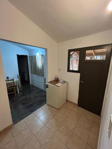a living room with a black door and a table at Luz de Luna in Trevelin