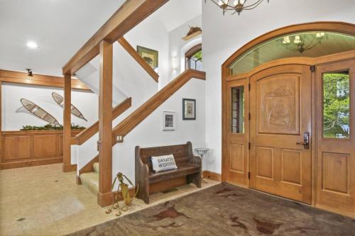 a hallway with a wooden door and a stair case at Lake Breeze Luxury Executive Retreat in Three Lakes