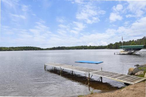 a dock in the middle of a lake at Lake Breeze Luxury Executive Retreat in Three Lakes