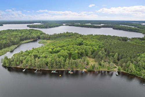 an island in a body of water with trees at Lake Breeze Luxury Executive Retreat in Three Lakes