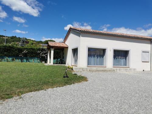 a white house with a lawn in front of it at La Maison De Titou in Lazer