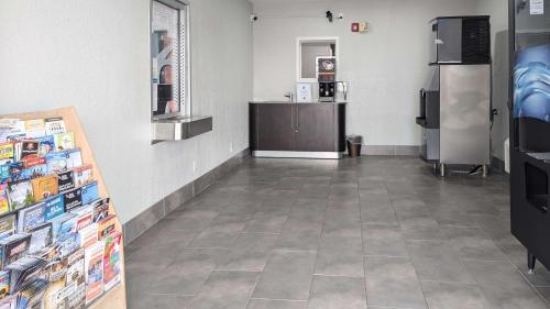 a grocery store aisle with a cash register and refrigerator at Motel 6-Victoria, TX in Victoria