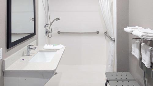 a bathroom with a sink and a mirror and towels at Motel 6-Victoria, TX in Victoria