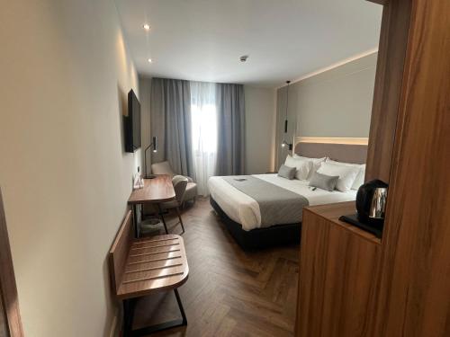 a hotel room with a bed and a table at Silken Rona Dalba in Salamanca