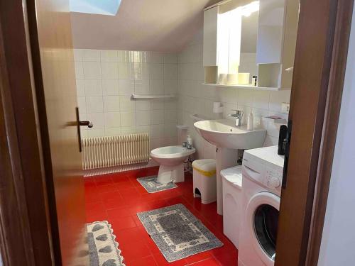 a bathroom with a toilet sink and a washing machine at loft in motta di livenza 30 mins from Venice in Motta di Livenza