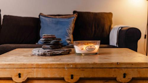 a candle on top of a wooden coffee table at The Bakers House in Elie