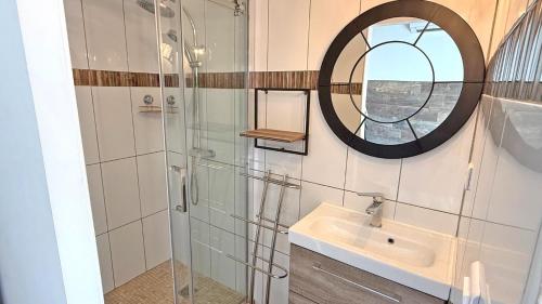 a bathroom with a shower and a sink and a mirror at Villa Pré d'Icard in Plan-de-la-Tour