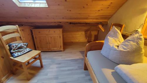 a room with a couch and a chair in a cabin at Hainich-Zeit in Eigenrieden