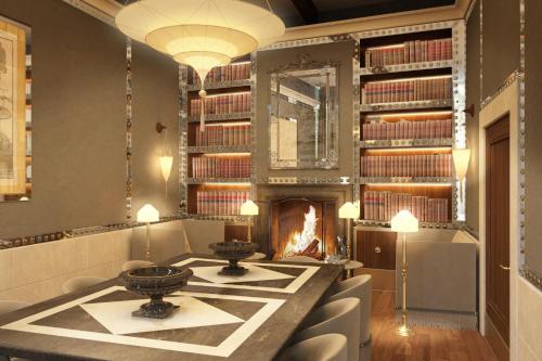 a room with a fireplace and shelves of books at Hotel Gabrielli Venezia - Starhotels Collezione in Venice