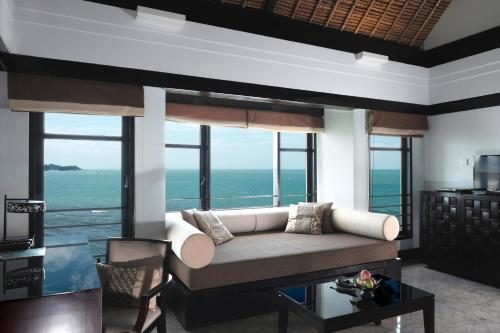 a living room with a couch and views of the ocean at Banyan Tree Bintan in Lagoi