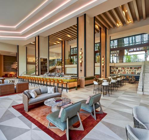 a lobby with couches and tables and a bar at Grand Hyatt Scottsdale Resort in Scottsdale