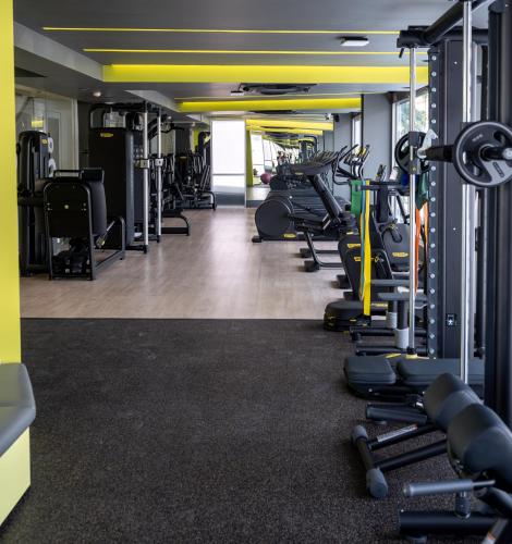 a gym with rows of treadmills and machines at jasminespace in Khlong San