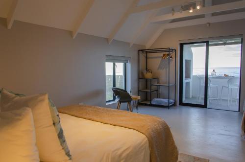 a bedroom with a bed and a view of the ocean at Bella La Vita Beachfront Villa in Velddrif