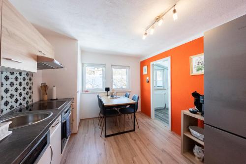 a kitchen with a sink and a table in it at Haus Frey in Altaussee