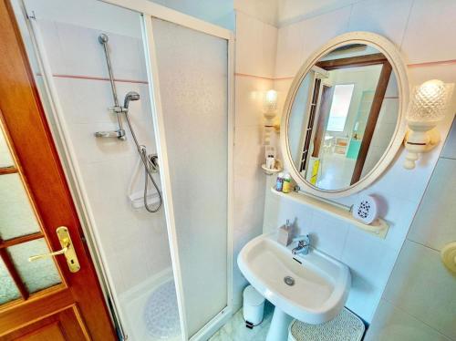 une petite salle de bain avec un lavabo et un miroir dans l'établissement Bilocale Fronte Mare, à Menton