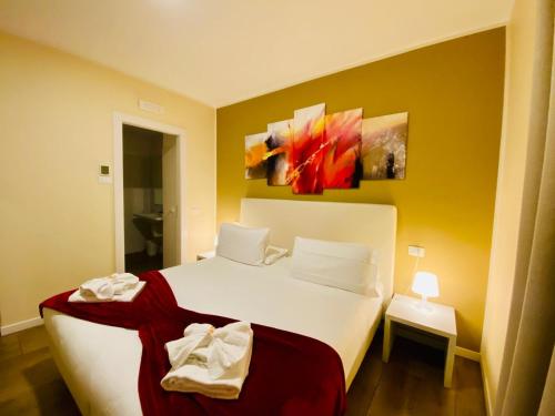 a bedroom with a white bed and a yellow wall at Verona Enjoy in Verona