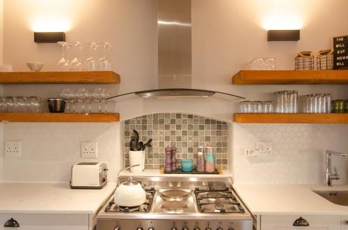 a kitchen with a stove top oven in a kitchen at Bella La Vita Beachfront Villa in Velddrif