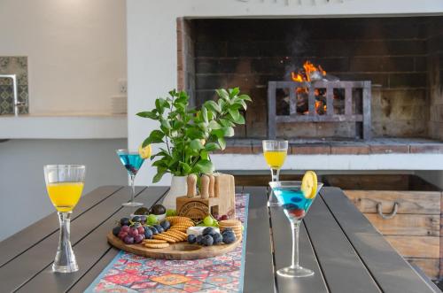 a table with a tray of food and glasses of wine at Bella La Vita Beachfront Villa in Velddrif