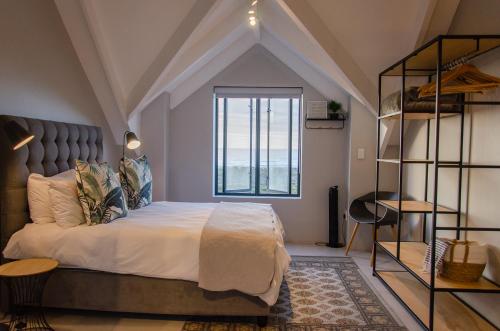 a bedroom with a large bed with a large window at Bella La Vita Beachfront Villa in Velddrif