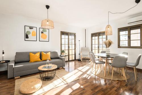 a living room with a couch and a table at Nordik Rooms Village - Torremolinos "Undredal" in Torremolinos
