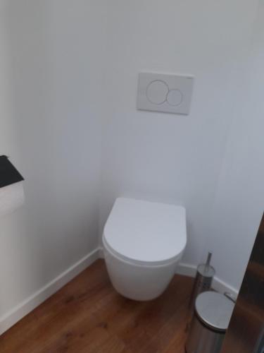 a bathroom with a white toilet in a room at La porte in Huy