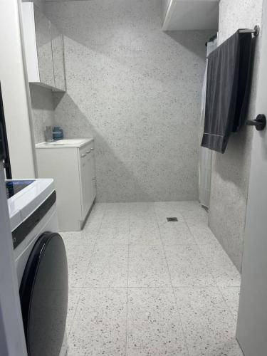 a small white bathroom with a sink and a toilet at Cosy Urban Retreat in the Heart in Toowoomba