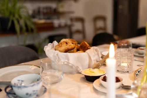 a table with a basket of food on a table at Folk och Fä in Grisslehamn