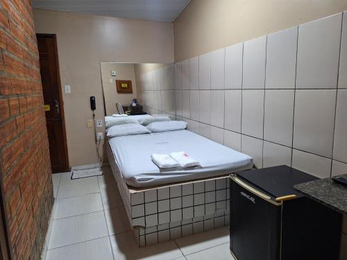 a small room with four beds in it at Pousada Tropical (Adults Only) in Marituba