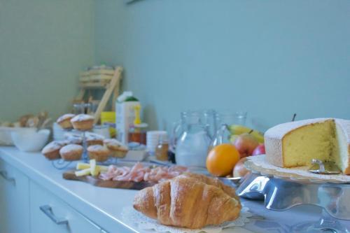 a table with bread and pastries and other foods on it at B&B Il Riccio in Tirano