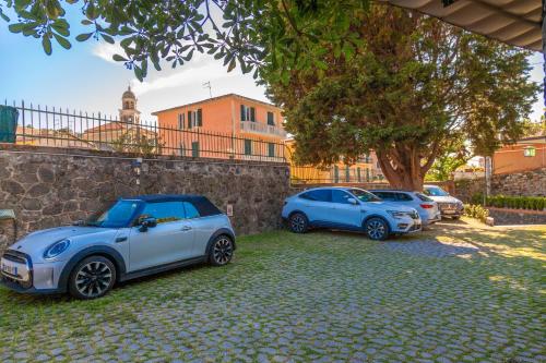a group of cars parked next to a stone wall at PORTOVECCHIO Plus in Levanto