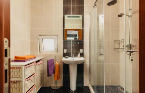 a bathroom with a sink and a shower at Panoramic Bliss in Herceg Novi in Herceg-Novi
