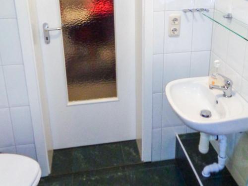 a bathroom with a sink and a toilet at Ferienwohnung Am Recknitzhang in Carlewitz