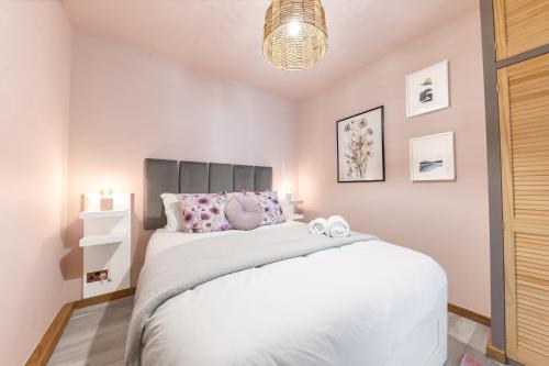 a bedroom with a white bed with two stuffed animals on it at Southview Spa Windermere in Windermere