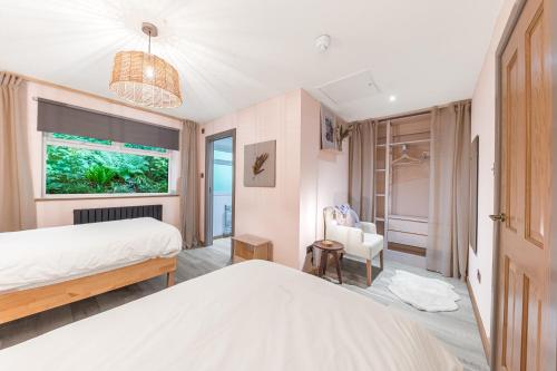 a bedroom with two beds and a window at Southview Spa Windermere in Windermere