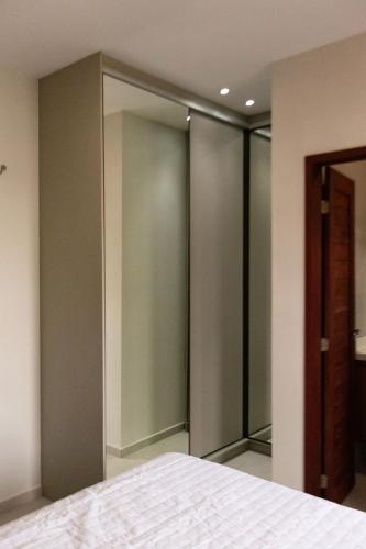 a bedroom with sliding glass doors and a bed at Chale Lady Clara Encanto e Conforto nos Lencois MA in Santo Amaro