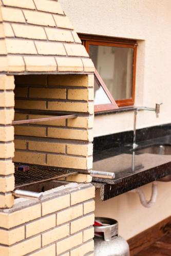 a stack of bricks sitting on top of a brick oven at Chale Lady Clara Encanto e Conforto nos Lencois MA in Santo Amaro