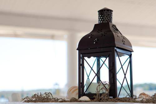 a black lantern sitting on top of a table at Bay Pointe Inn in Orangeville