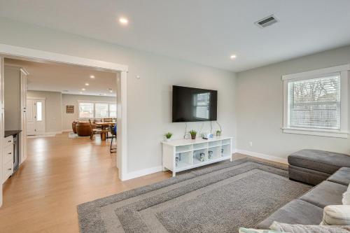 a living room with a couch and a tv on a wall at Modern Cape Cod Home with Patio 2 Mi to Beaches! in Hyannis