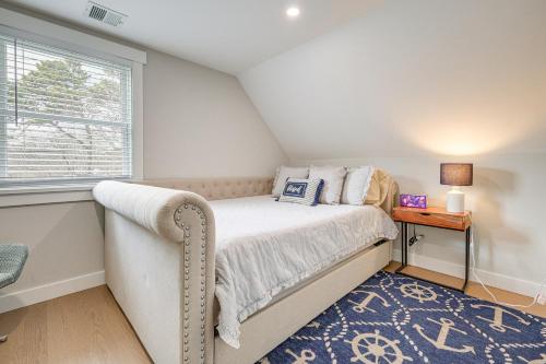 a small bedroom with a bed and a window at Modern Cape Cod Home with Patio 2 Mi to Beaches! in Hyannis