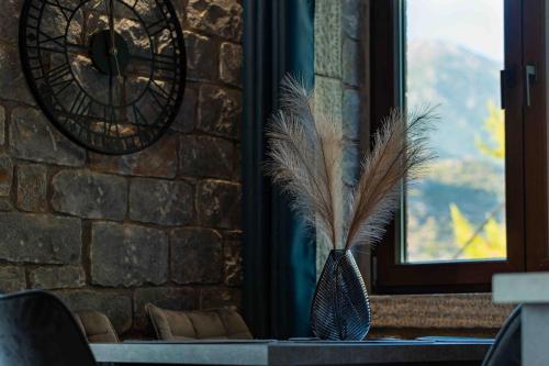a vase with feathers in it next to a window at Modern Loft at Kalogria Beach in Stoupa